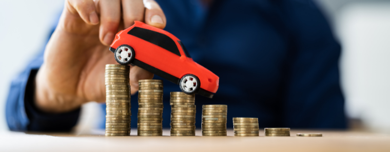 vehicle sitting on top of a descending pile of coins