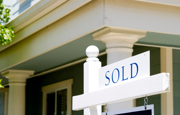 sold sign in front of house